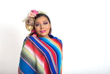 Mexican woman with flower headdress wrapped in a colorful serape. White background.