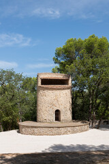 Fototapeta na wymiar 19th-century Fuveau pigeonnier: 22m stone tower, Provençal landmark. Once a windmill, now historic gem, France
