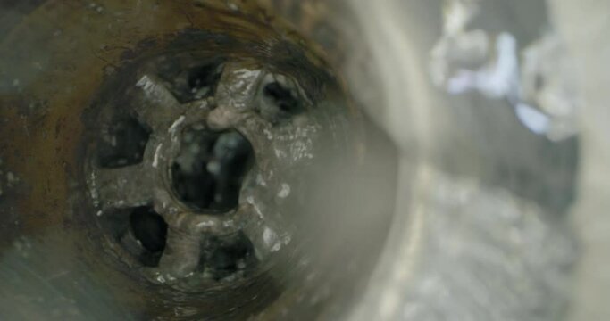 Close-up of a dirty drain in a dishwasher. Washing dishes and clogging sewers with food waste. High quality 4k footage