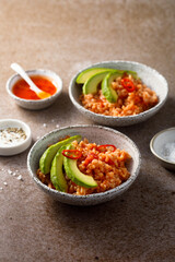 Spicy rice with avocado and chili sauce
