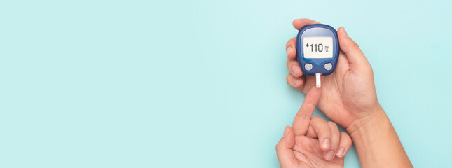 Man using glucometer, checking blood sugar level.