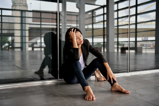 Asian businesswoman is stressed in the city. She is feeling depressed about her bankrupt life.