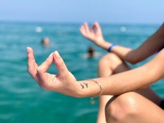 Meditation on the beach. Woman Sitting On Beach With Yoga Lotus Position.