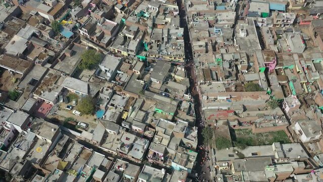 Aerial view of people celebrating the holy colour festival in the street in Barsana, Uttar Pradesh, India.