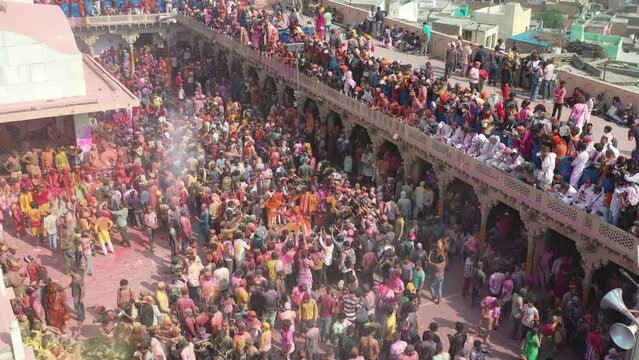 Barsana, India - 28 February 2023: Aerial view of people celebrating the holy colour festival in the street in Barsana, Uttar Pradesh, India.