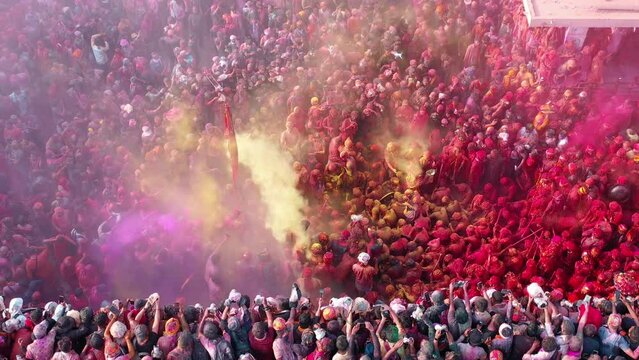 Barsana, India - 28 February 2023: Aerial view of people celebrating the holy colour festival in the street in Barsana, Uttar Pradesh, India.