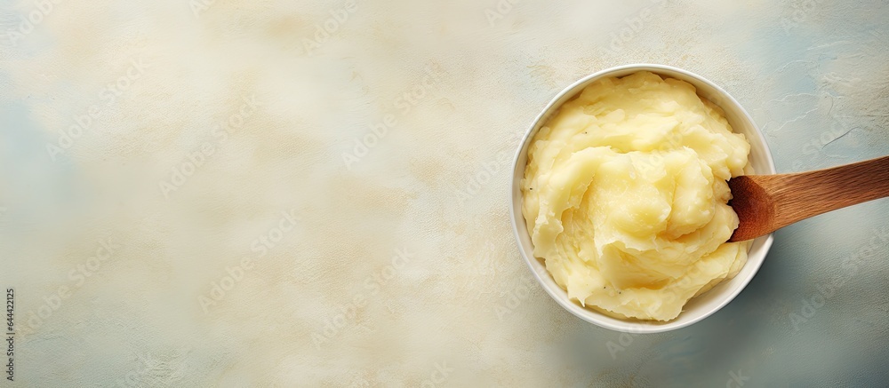 Poster potatoes mashed in large pot with spoon isolated pastel background copy space