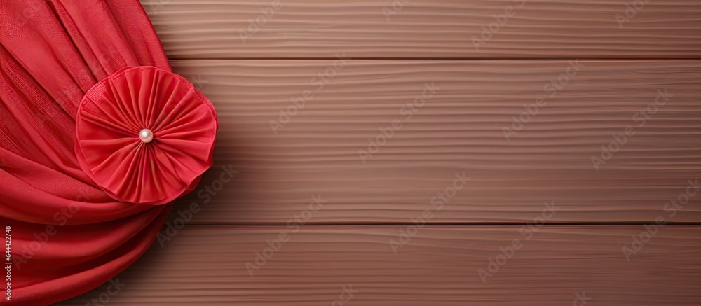 Poster Red fabric brooch with threads on isolated pastel background Copy space en table resembling a mockup