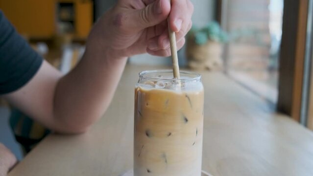 Man Drinking Iced Latte Coffee In A Glass With A Straw In Coffee Shop. Cold Summer Refreshment Drink