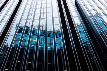 Modern abstract reflections in glass fronted commercial office buildings in the financial district...