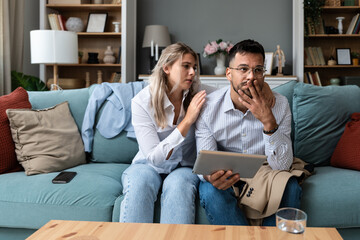 Woman comforts her husband who was confirmed via received email on tablet that he got fired at work...