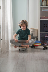 Positive kid with skateboards in room