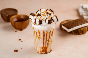 Caramel frappe with Ice Cream sandwich with chocolate served in glass isolated on table top cafe dessert Frappuccino Blended drink