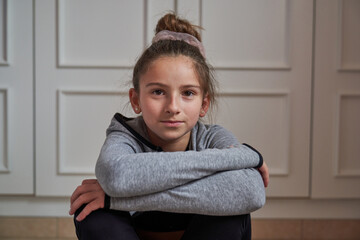 Fototapeta premium Portrait of gymnastic girl sitting at home