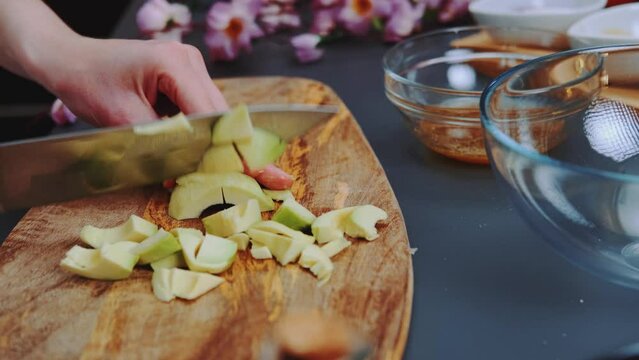 Female chef slices avocado. Close-up shot of table. Cooking in the kitchen.