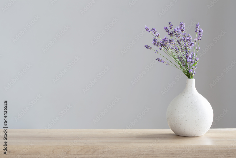 Wall mural lavender flowers in ceramic vase on gray background