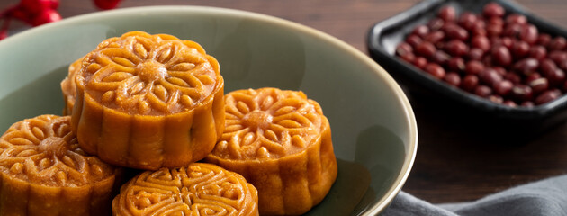 Delicious Cantonese moon cake for Mid-Autumn Festival food mooncake on wooden table background.