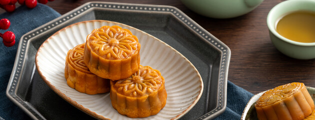 Delicious Cantonese moon cake for Mid-Autumn Festival food mooncake on wooden table background.