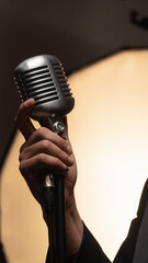 singer with microphone in hand - obrazy, fototapety, plakaty