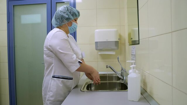 The doctor washes his hands before the operation.
