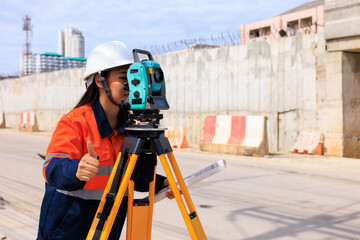 engineer use theodolite equipment  for route surveying to build a bridge across the intersection to reduce traffic congestion during rush hours