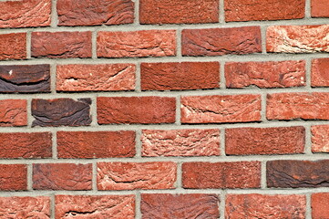 Abstract background photo of wall made of orange bricks. Lovey plastic texture facing on the building. Possible to use as pattern background.