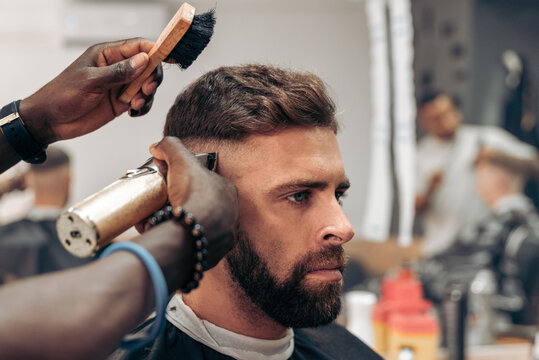 Man getting professional haircut in barbershop