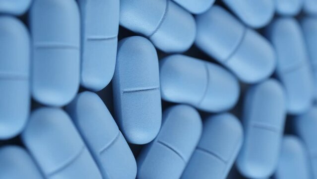 Blue pills close up, rotation. Pharmaceutical Industry. Vertical video