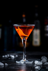 Bobby Burns strong cocktail drink with scotch whiskey, vermouth and liquor in martini glass, dark bar counter background