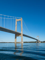 Den nye Lillebæltsbro stretching from Funen to Jutland in Denmark across the Lillebælt strait. Blue sky and sunny summer weather.