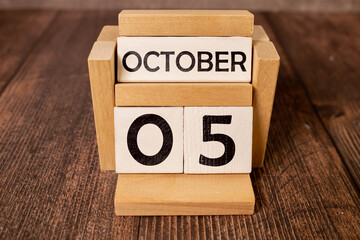 Wooden calendar October 05 on a white background close up