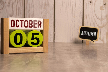 October 05th. October 05 wooden cube calendar with blur objects on background.