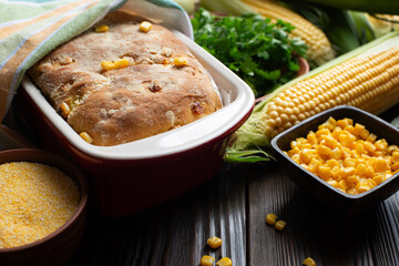 Cornbread in ceramic baking dish on wooden kitchen table
