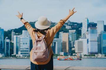 Asian tourist, cute woman with long hair are traveling in Hong Kong along with map and her camera...