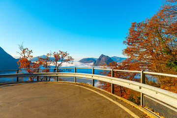 Mountain Peak San Salvatore Above Cloudscape and Mountain Road with Sunlight and Clear Sky in Lugano, Ticino in Switzerland.
