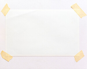 A blank frame attached on a paper page with adhesive tape. - 644458770