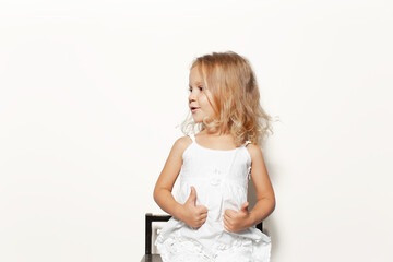 Studio portrait of smiling child girl isolated on white background.