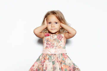 Studio portrait of child girl in dress isolated on white background.