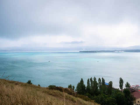 above view of Lake Sevan from Sevanavank monastery on cloudy summer day, Armenia