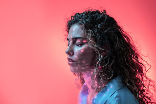 Attractive woman in room with neon lights