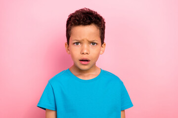 Photo portrait of charming small boy look confused unsure frustrated dressed stylish blue garment isolated on pink color background