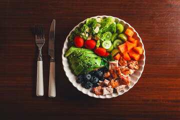 Healthy grilled chicken salad on white background