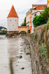 Fototapeta na wymiar Panoramic view Schaibling Tower and promenade on river Inn, Passau, Lower Bavaria, Germany. vertical photo