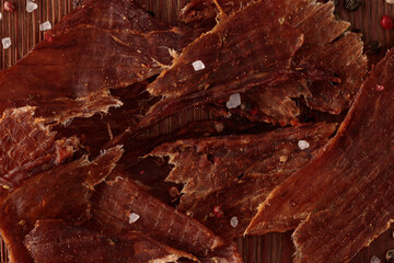 Sliced Dried Meat on Wooden Tabletop - Top View
