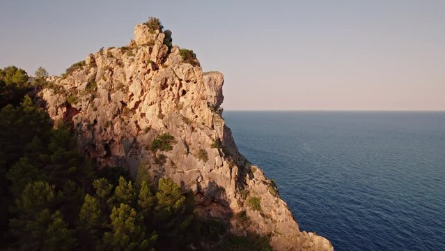 Aerial view of Breathtaking coastal panorama with clear blue sea, rugged cliffs, and the serene tranquility of small holiday houses,  Cala Moraig, Zona Encinas, Cumbre del Sol, Alicante, Spain