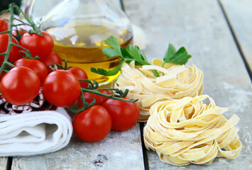 fresh organic tomatoes and basil on wooden background