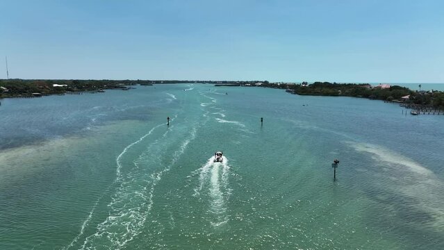 Aerial view of a motorboat sailing along Lyons Bay in Casey Key, Florida, United States.