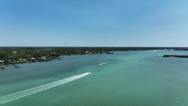 Aerial view of a motorboat sailing along Lyons Bay in Casey Key, Florida, United States.