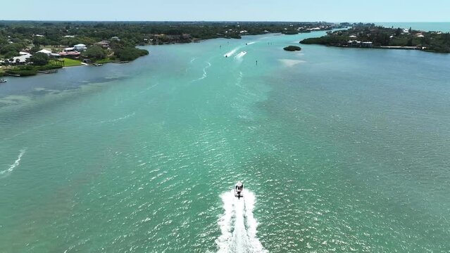 Aerial view of a motorboat sailing along Lyons Bay in Casey Key, Florida, United States.