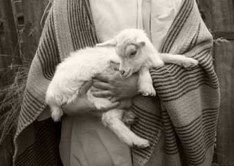 Shepherd with a sheep in his arms